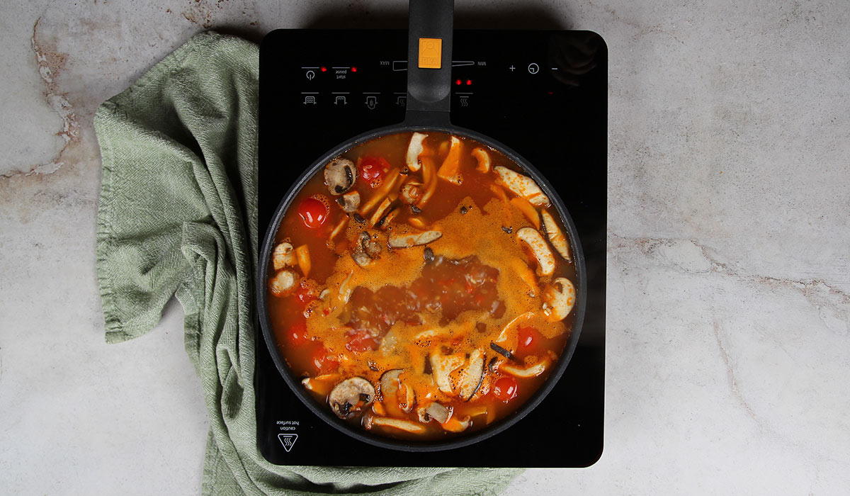 Caldo en arroz meloso con setas